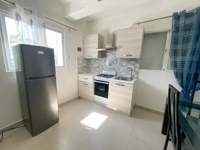 a kitchen with a refrigerator and a stove in it at Vintage Villa confortable apartments Wifi private pool free parking in Boca Chica