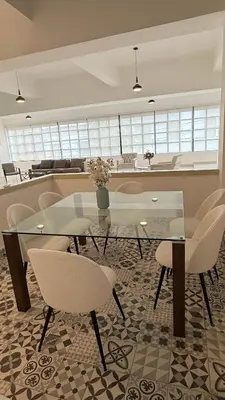 a dining room with a glass table and chairs at Soho loft residence in Santo Domingo