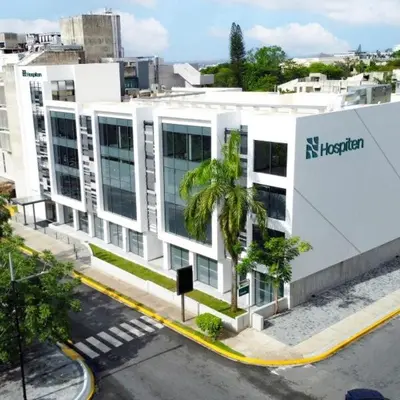 a white building with a sign on the side of it at Apto céntrico con piscina, gym y una hermosa vista a la ciudad in Santo Domingo