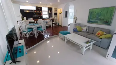 a living room with a couch and a table at Cabarete Heartbeat Suite, 1 BR in Cabarete