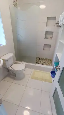 a white bathroom with a toilet and a shower at Cabarete Heartbeat Suite, 1 BR in Cabarete