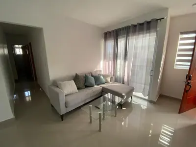 a living room with a couch and a table at Cozy Tropical Getaway in Los Altos de Jalisco