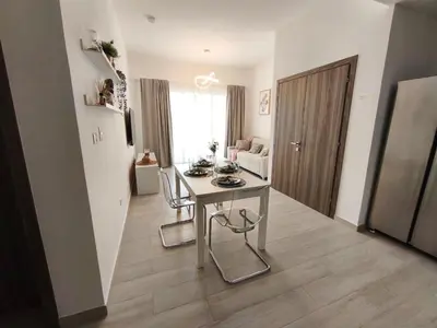 a kitchen with a table and chairs in a room at Apartamento Cómodo en Punta Cana in Punta Cana
