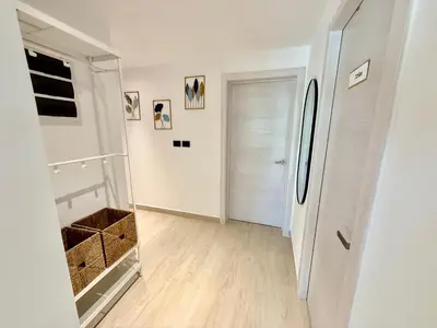 a white room with a refrigerator and a hallway at Tropical Escape with 3 Pools & Private Beach Club Aqua Esmeralda in La Laguna