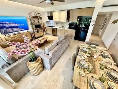 a living room with a couch and a table at Tropical Escape with 3 Pools & Private Beach Club Aqua Esmeralda in La Laguna