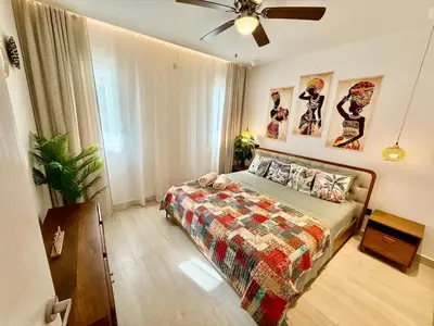 a bedroom with a bed and a ceiling fan at Tropical Escape with 3 Pools & Private Beach Club Aqua Esmeralda in La Laguna