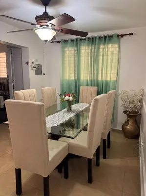 a dining room with a glass table and chairs at Acogedor y céntrico apartamento en Palmas de Gurabo in Santiago de los Caballeros