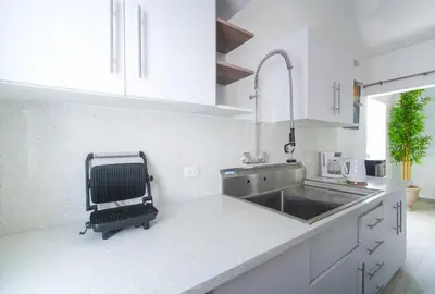a kitchen with a sink and a chair in it at La casa del Maestro apartment in Bayahibe