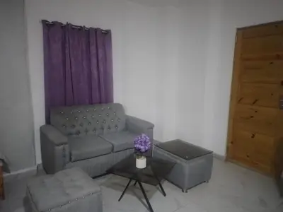 a living room with a couch and a table at Home Realty in Santo Domingo