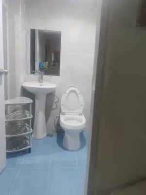 a bathroom with a toilet and a sink at Home Realty in Santo Domingo