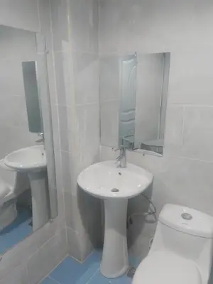 a white bathroom with a sink and a toilet at Home Realty in Santo Domingo
