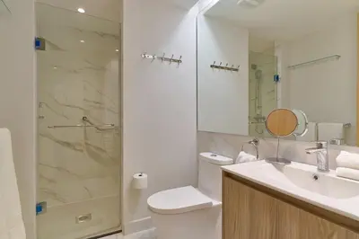 a bathroom with a shower and a toilet and a sink at ®{Peaceful~Retreat} @DowntownSD HotTubGymFamily in Santo Domingo