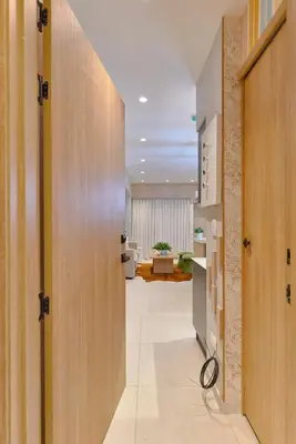 a hallway with wooden doors and a living room at ®{Peaceful~Retreat} @DowntownSD HotTubGymFamily in Santo Domingo