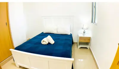a bed with two towels on it in a room at Apartamento en Boca Chica T1 302 in Boca Chica