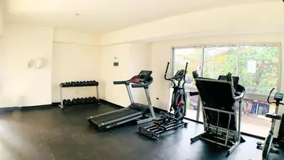 a gym with treadmills and exercise bikes in a room at Apartamento en Boca Chica T1 302 in Boca Chica