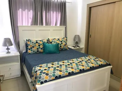 a bedroom with a bed with a blue comforter at Apartamento en Boca Chica T2 501 in Boca Chica