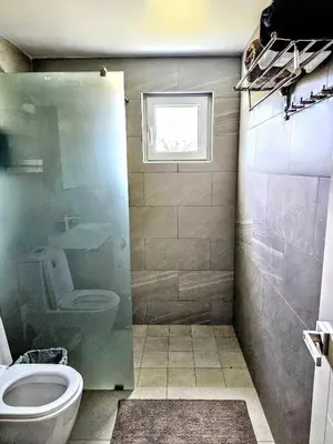 a bathroom with a toilet and a window at NEW Luxury at Sosua Ocean Village Laguna City in Sosúa