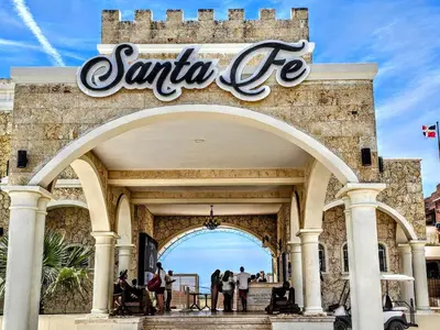 people standing under the santa fe sign at the entrance to a building at NEW Luxury at Sosua Ocean Village Laguna City in Sosúa