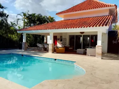 a villa with a swimming pool and a house at Villa en Guababerry in Los Conucos