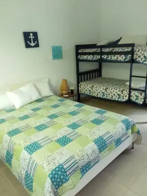 a bedroom with a bed and a shelving unit at Villa en Guababerry in Los Conucos