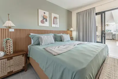a bedroom with a large bed with blue sheets at Privacy, Big, Exclusive in Sosúa in Sosúa