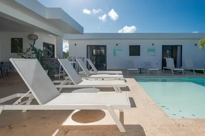 a row of lounge chairs next to a swimming pool at Privacy, Big, Exclusive in Sosúa in Sosúa