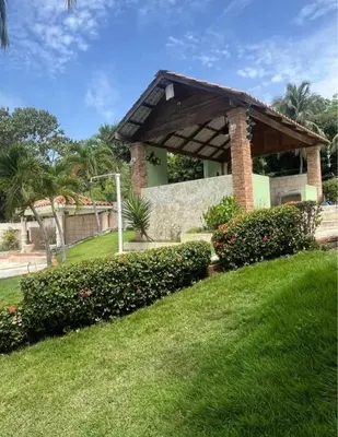 a building with a pavilion in a green yard at Emmanuel villas luxury in Puerto Plata