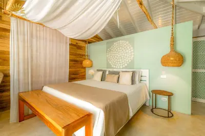 a bedroom with a bed with a wooden ceiling at Mahona Boutique Hotel in Las Terrenas