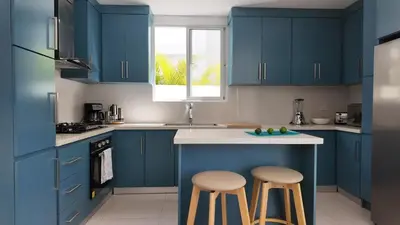 a kitchen with blue cabinets and two stools at Beach House With Private Pool in Las Terrenas