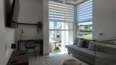 a living room with a couch and a large window at Beach House With Private Pool in Las Terrenas