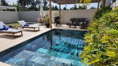a swimming pool with chaise lounge chairs and a patio at Beach House With Private Pool in Las Terrenas