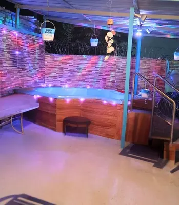 a hot tub in a room with a brick wall at Country house with Jacuzzi and BBQ