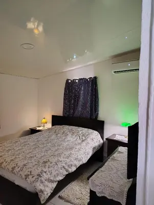 a bedroom with a bed and two night stands at Country house with Jacuzzi and BBQ