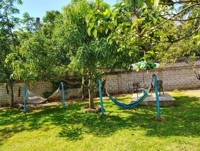 three hammocks in a yard next to a tree at Country house with Jacuzzi and BBQ