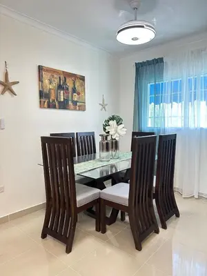 a dining room with a glass table and chairs at Vista Azul Boca Chica Accommodation in El Higo