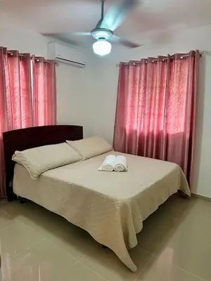 a bedroom with a bed with two towels on it at Modern, Elegant & Comfortable Apartment in El Seis