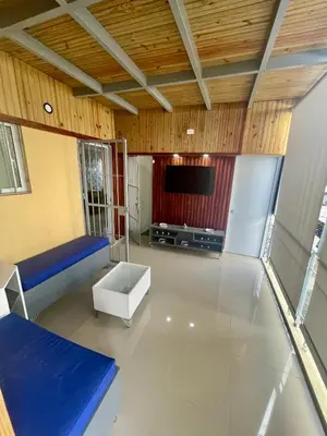 a large living room with a couch and a tv at La Casita De Chucho in Santiago de los Caballeros