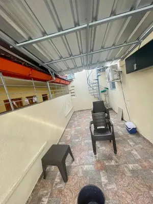 an empty room with two chairs and a table at La Casita De Chucho in Santiago de los Caballeros