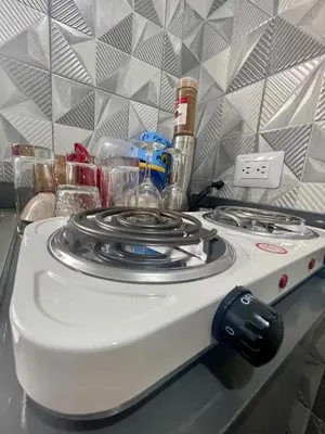 a stove top oven sitting on top of a counter at La Casita De Chucho in Santiago de los Caballeros