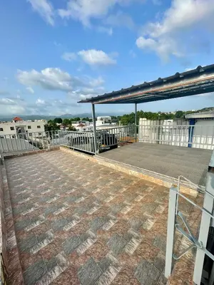 a deck with a roof with a metal structure at La Casita De Chucho in Santiago de los Caballeros