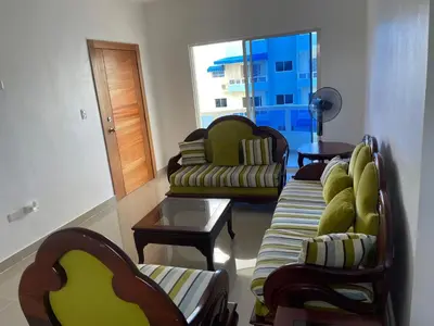 a living room with a couch and chairs and a table at Comodo apartamento en Boca Chica SDQ AILA in El Higo