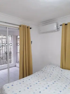 a bedroom with a bed and a window at Studio Apartment 5 - SML Garden in La Romana