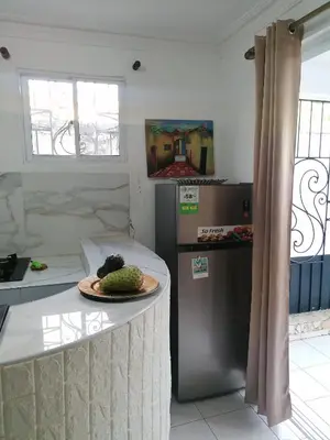 a kitchen with a table with a plate of food on it at Studio Apartment 5 - SML Garden in La Romana