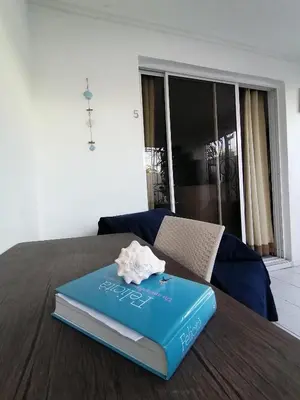 a book sitting on top of a bed at Studio Apartment 5 - SML Garden in La Romana