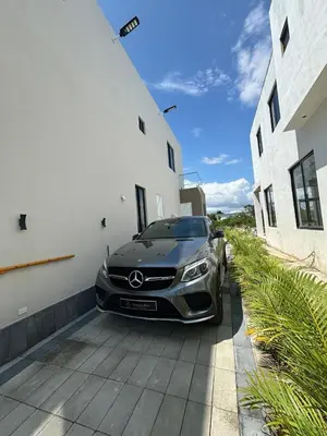 a car parked in a garage next to a building at Villa Aguacate Near the Beach in Juan Dolio