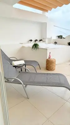 a patio with two chairs and a table at SoHo Loft Penthouse in Santo Domingo