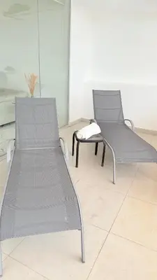 two chairs and a bench in a room at SoHo Loft Penthouse in Santo Domingo