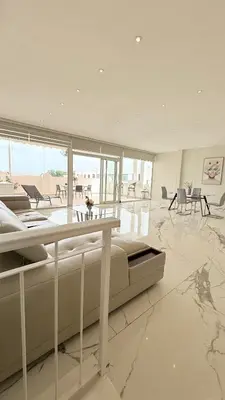 a large white room with a bed and a table at SoHo Loft Penthouse in Santo Domingo
