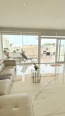 a living room with a couch and a table at SoHo Loft Penthouse in Santo Domingo