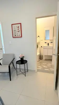 a living room with a chair and a table and a bathroom at SoHo Loft Penthouse in Santo Domingo